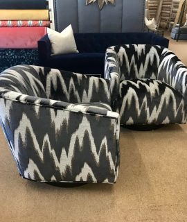 Two patterned swivel chairs with a zigzag design in a cozy room.